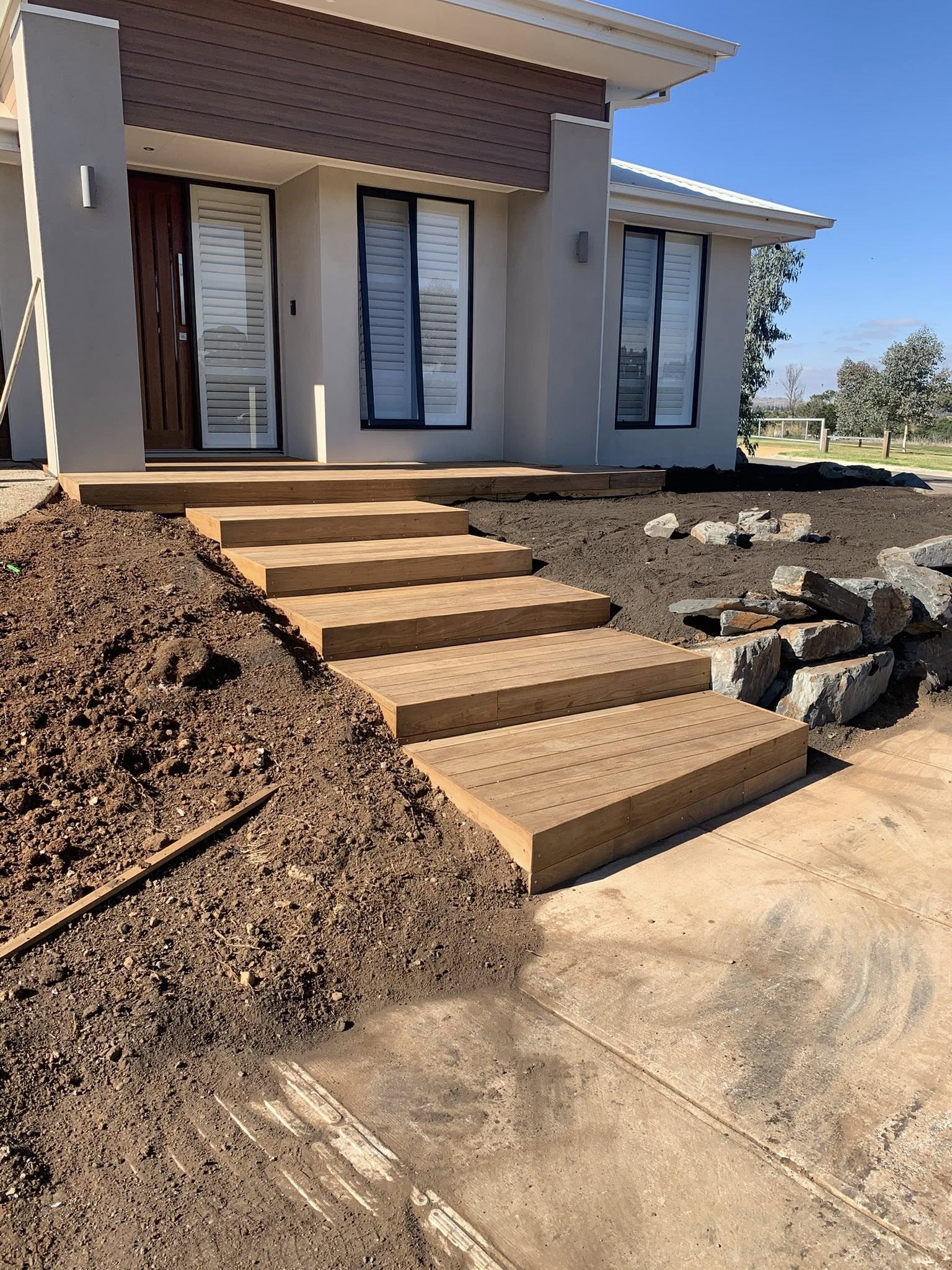Sloped front yard tallowwood stairway